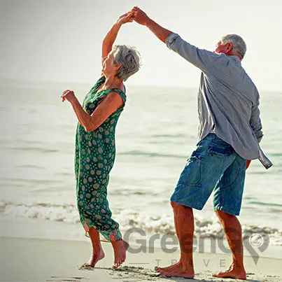 galapagos-cruises-for-families - elderly couple dancing on the beach