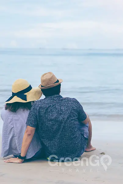 Seaman Galapagos Cruise Honeymoon-Packages-Honeymoon Couple sitting on beach