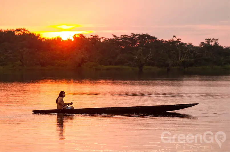 Ecuador vs Peru Man in canoe flaoting down Amazon river